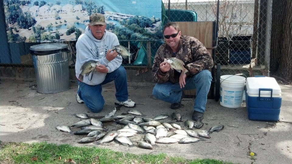 Two fishers holding their catch.