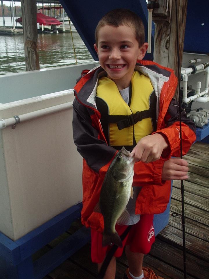 Child holding a fish.