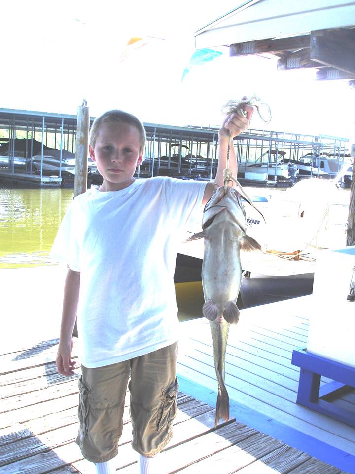 Child holding a catfish.